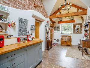 a kitchen with blue cabinets and a table in a room at 1 Bed in Eden Valley 82493 in Kirkoswald