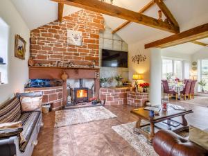 a living room with a fireplace and a brick wall at 1 Bed in Eden Valley 82493 in Kirkoswald
