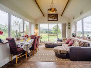 a living room with a couch and a table and chairs at 1 Bed in Eden Valley 82493 in Kirkoswald