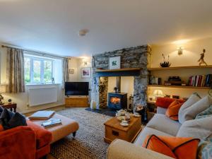 a living room with a stone fireplace and couches at 1 Bed in Bethesda 82577 in Llanddeiniolen