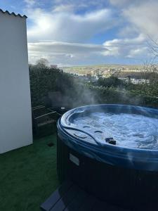 a large blue hot tub sitting on top of a yard at HillTop View 'Sleeping 5 guests' in Derry Londonderry