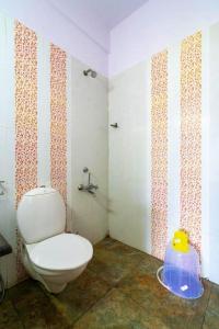 a bathroom with a white toilet in a room at The View Munnar in Anachal