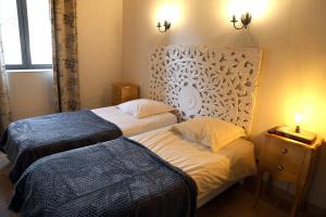 1 dormitorio con 2 camas, cabecero y ventana en Domaine de la Vidalle, en Vendres