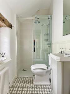 a bathroom with a shower and a toilet and a sink at Grange Barn, Ashford In The Water in Great Longstone