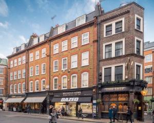 a large brick building on the corner of a street at Soho super apartment in London