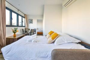 蒙魯日的住宿－Amazing Appartment 4 Peoples，卧室配有白色床和黄色及白色枕头