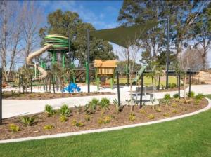 a playground with a slide in a park at Spectacular 3 Bedroom, 2 Bathroom Home. in West Swan