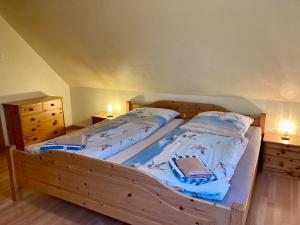 two twin beds in a bedroom with two night stands at Nordsee 409 in Wangerooge +2 photos