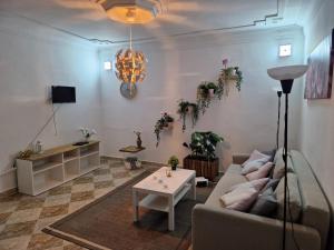 a living room with a couch and a table at Dar Saphire Apartments in Chefchaouen