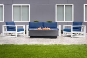 two blue and white chairs and a fire pit at stayAPT Suites Cleveland TN in Cleveland