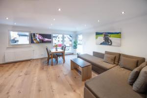 a living room with a couch and a table at Haus an der Haslach in Lenzkirch