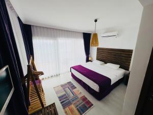 A bed or beds in a room at Fuda Hotel