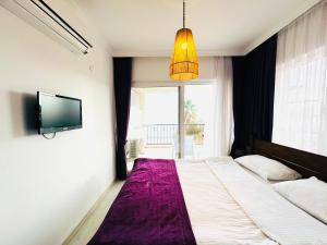 A bed or beds in a room at Fuda Hotel