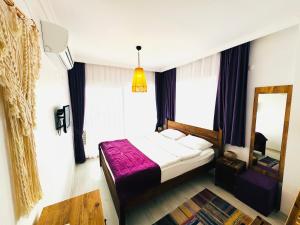 A bed or beds in a room at Fuda Hotel