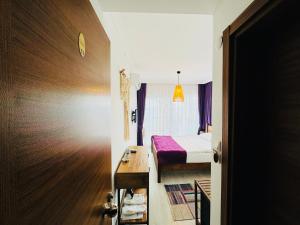 A bed or beds in a room at Fuda Hotel