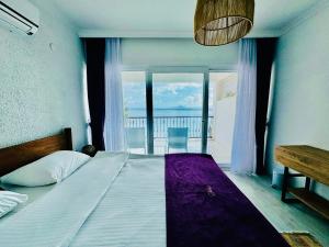 A bed or beds in a room at Fuda Hotel
