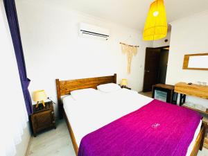 A bed or beds in a room at Fuda Hotel