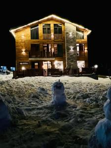 a building in the snow in front of a building at Chalet In Gudauri in Gudauri