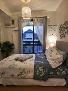 a bedroom with a bed and a window with a view at Casa Lucas in Tagaytay