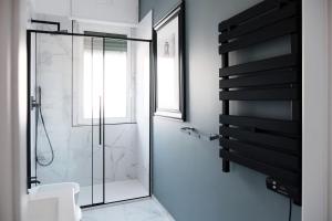 a bathroom with a shower with a glass door at ComeCasa Città Studi Terraced Apartment in Milan
