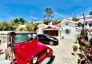 a red jeep parked in front of a house at Hidden doors in Ooty