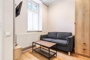 a living room with a couch and a table at Tiny and cosy studio only 4 you in Katowice