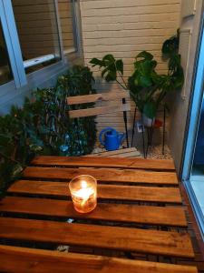 a candle on a wooden bench on a porch at La Azotea de Cristina in Seville