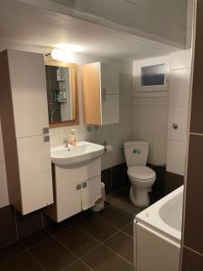 a small bathroom with a sink and a toilet at Stone Apartment in Thessaloniki