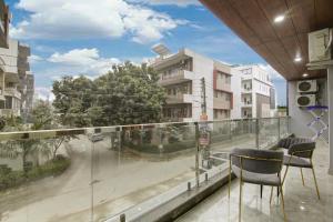 a balcony with chairs and a view of a street at Limewood Stay - Millennium Huda city center in Gurgaon
