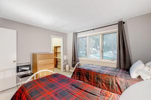 a bedroom with two beds and a window at Forest Hideaway in Waterville Valley