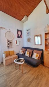 a living room with a blue couch and a table at Apartment for 6 people in the heart of Valberg resort in Valberg