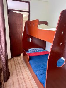 a room with two bunk beds with a mirror at Kijani Kibichi Cottages in Naro Moru