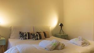 1 dormitorio con 2 camas y toallas. en Free parking - 700 m dalla spiaggia - ROME airport - Roseto Villa Dream en Fregene