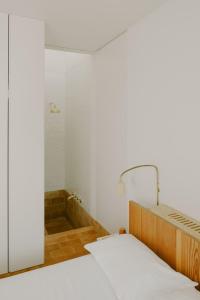 a bedroom with a bed and a mirror at Casa Modesta in Olhão