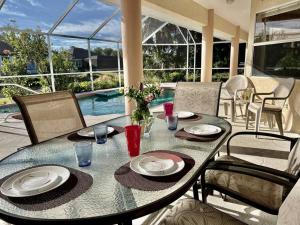 a dining table with plates and glasses on a patio at Villa with swimming pool & spa in quiet area in Rotunda-West