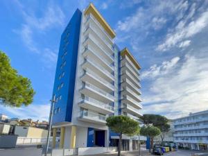 een blauw-wit gebouw op een straat bij Apartments in Lignano Sabbiadoro 31391 in Lignano Sabbiadoro