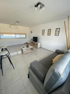 a living room with a couch and a table at Edificio Farfalle -Cochera incuida in La Plata