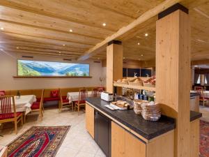 a dining room with a table and a tv at Hotel Glockenstuhl in Gerlos