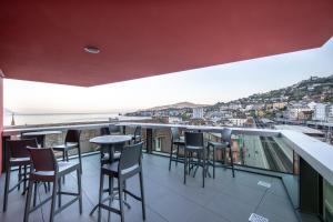 a bar with chairs and tables on a balcony at "The Freddie Mercury" Hotel in Montreux