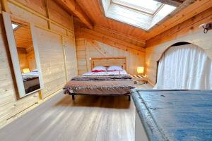 a bedroom with a bed in a wooden cabin at Peaceful chalet near the ski slopes 8 people in Fontrabiouse