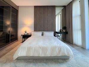 een slaapkamer met een groot wit bed en een bureau bij Villa 72 RAK in Ras al Khaimah
