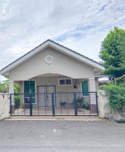 a house with a gate in front of it at Homestay Othman Perlis-14pax-AC-Wifi-Kangar-BBQ in Kangar