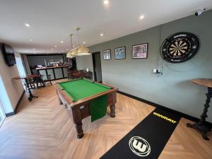 a room with a pool table and a dart board at The Fishmongers Tavern in Sheringham