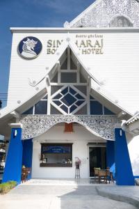 a building with a sign for a la jaza hotel at Singharaj Boutique Hotel in Chiang Mai