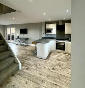 a kitchen with white cabinets and a counter top at Entire Town House In Liverpool Marina in Liverpool