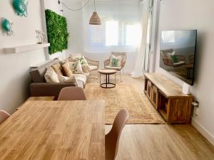 a living room with a table and a couch at Dolce Terrassa 25 min Barcelona and Beach in Terrassa