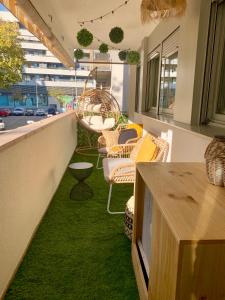 a patio with green grass and chairs and a table at Dolce Terrassa 25 min Barcelona and Beach in Terrassa