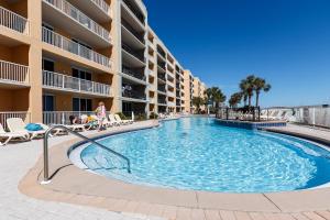 a swimming pool in front of a apartment building at Azure #610 - Jack's Beach House - Top Floor Luxury in Fort Walton Beach