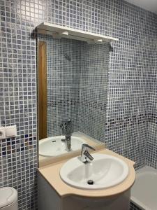 a bathroom with a sink and a mirror and a toilet at Marival - Playa Langosteira - Fisterra - Finisterre in Fisterra