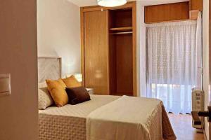 a bedroom with a bed and a window at Marival - Playa Langosteira - Fisterra - Finisterre in Fisterra